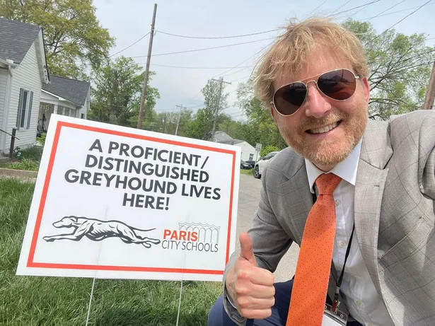 Stephen celebrating a student achievement outside the school