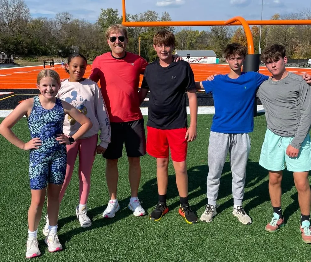 Stephen McCauley with Paris Middle School students after running timed miles with every PE class
